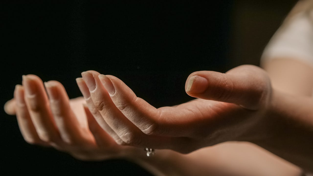 A close-up of open hands cupped together, symbolizing openness and spirituality.